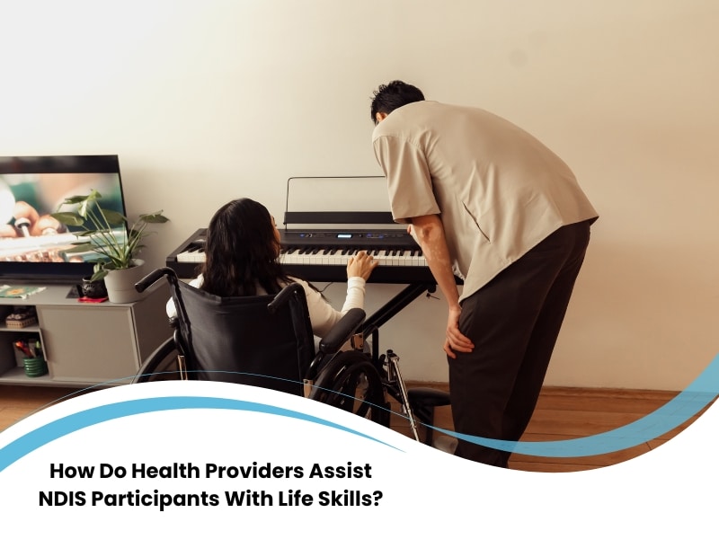 Health provider assist NDIS participant in wheelchair learning keyboard skills in home setting.